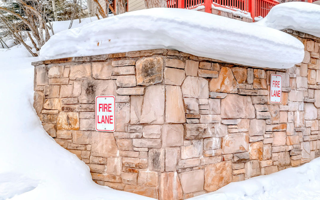 Stone retaining wall with Fire Lane sign