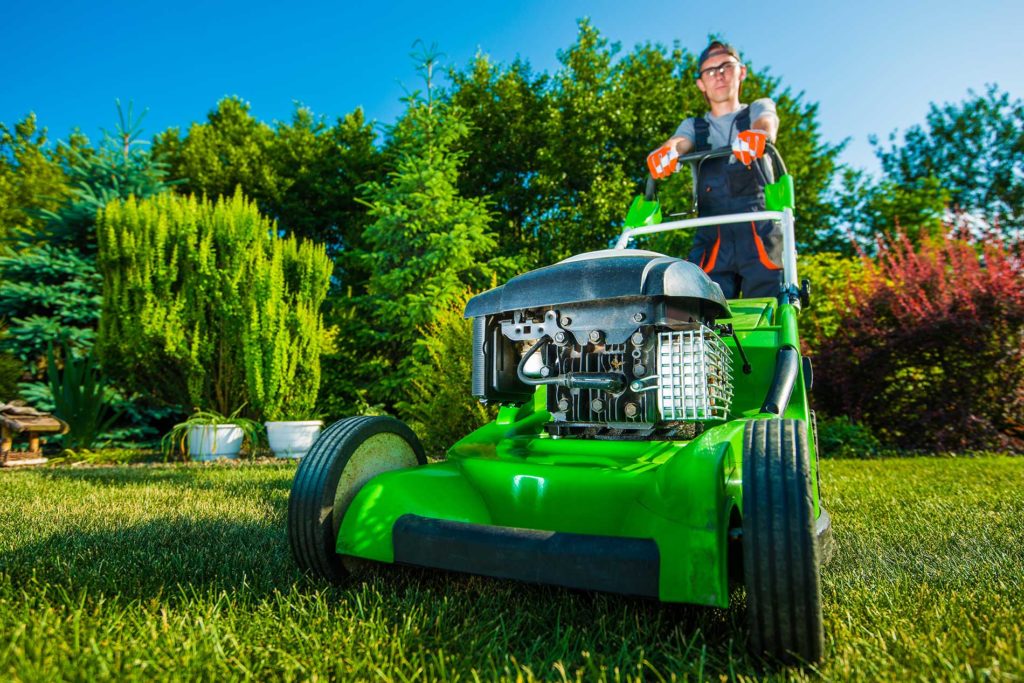 landscaping technician mowing the lawn