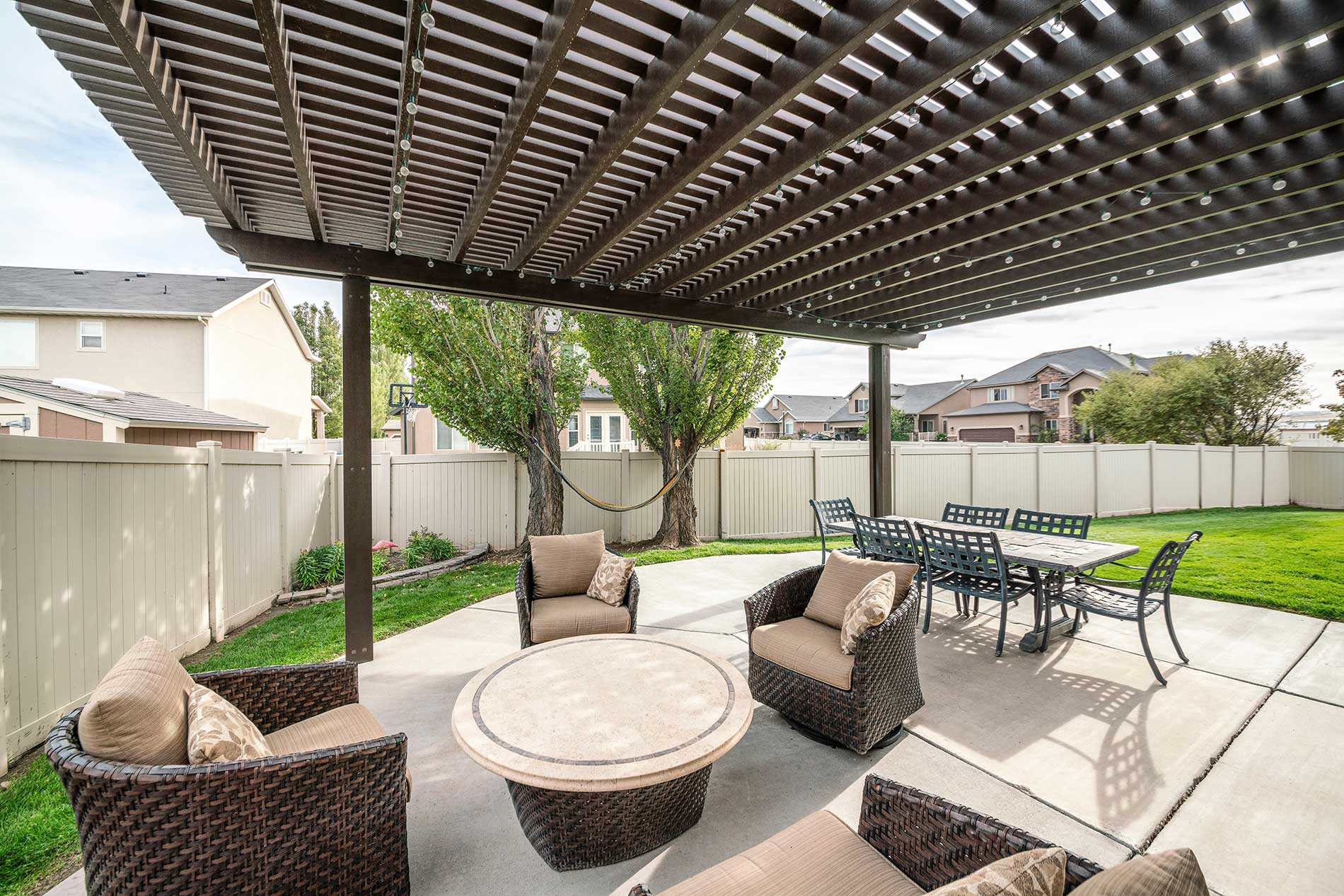 patio outside with chairs and tables around lawn