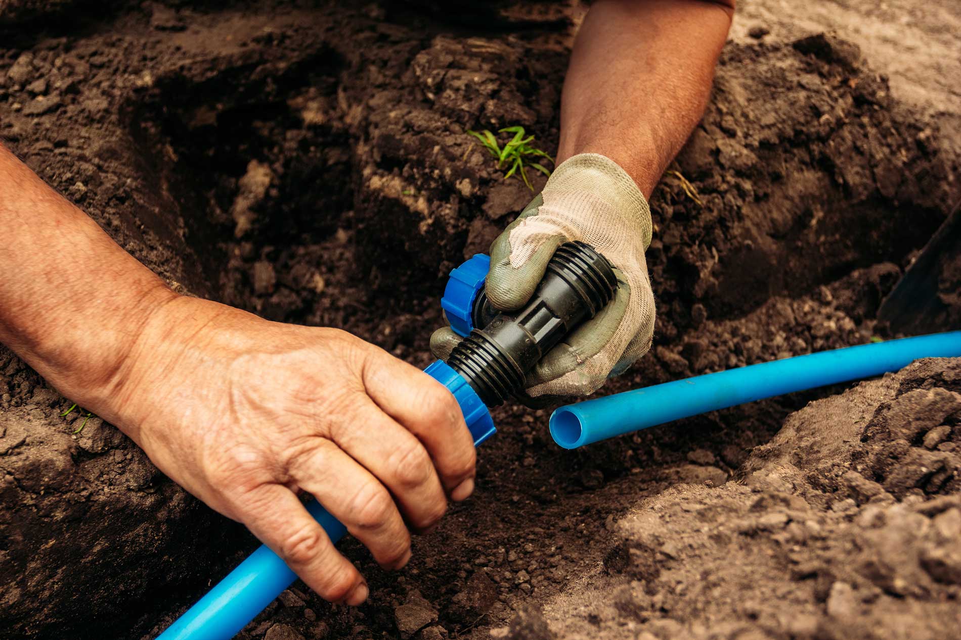technician putting together pipes for water work
