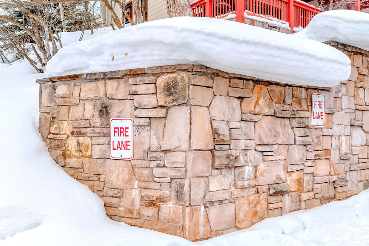 Stone retaining wall with Fire Lane sign