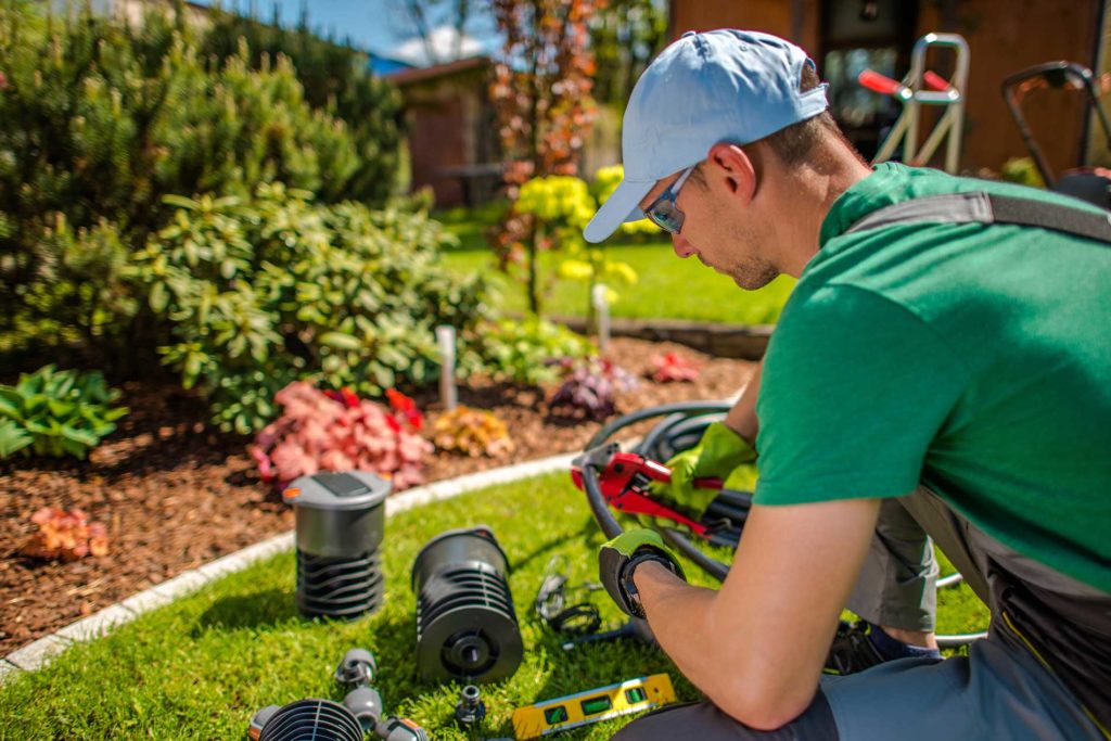 irrigation-technician-working-on-some-pipes irrigation-technician-working-on-some-pipes
